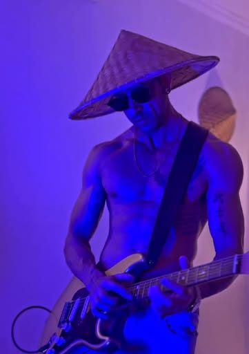 Jasper with electric guitar under blue light